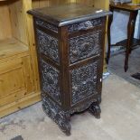 A 19th century dark oak bedside cabinet, with heavily carved drawer and cupboard doors, W40cm,