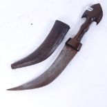An Arab curved Jambiya dagger, with carved horn hilt and original embossed leather scabbard, blade