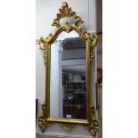 A gilt-framed wall mirror with applied decoration, W50cm, L100cm