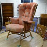 An Ercol Windsor armchair, with upholstered seat and back