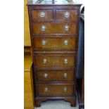 A reproduction narrow chest, with brushing slide and fitted drawers, W50cm, H119cm, D42cm