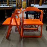 A set of 6 1970s Italian orange plastic folding chairs, with moulded mark - Made in Italy