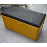 A polished pine-framed ottoman with upholstered seat, W92cm