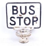 A Vintage relief cast-iron bus stop sign, on iron base, overall height 35cm