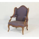 French walnut and upholstered wing armchair, late 19th Century, upholstered throughout in blue and