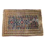 Kazak woollen rug, the deep blue field with geometric motifs within a patterned border, size approx.