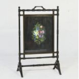 Victorian Aesthetic period ebonised firescreen, circa 1885, centred with a foliate painted fabric