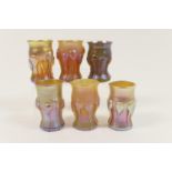 Six Tiffany glass lustre liqueur cups, each of waisted form with applied vertilinear trailing prunts