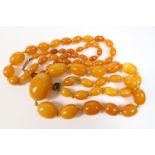 Butterscotch amber beaded necklace, graduated oval beads, the largest being 28mm, length 44cm, gross