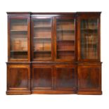 Mahogany inverted breakfront library bookcase, circa 1820-40, having an ogee moulded cornice over