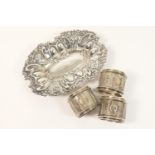 Three Victorian silver napkin rings, by Edward Hutton, London 1890; also an Edwardian silver