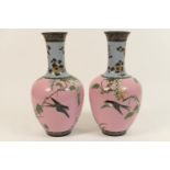 Pair of Japanese pink ground cloisonne vases, of bottle form decorated with swallows flying amidst