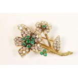 Attractive diamond and emerald floral spray brooch, possibly French, early 20th Century, set with 71