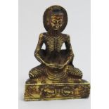 Sino-Tibetan small gilt bronze of the emaciated Buddha Siddhartha, with an aureole at the back of