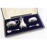 George V silver three piece condiment, Birmingham 1928, comprising pepper pot, wet mustard pot, salt