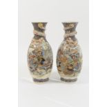 Pair of Japanese satsuma vases, Taisho (1912-26), ovoid form relief moulded with a dragon at the