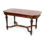 Victorian mahogany library table, in the French taste, the shaped rectangular top with gilt tooled
