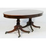 Late Regency mahogany twin pedestal extending dining table, the oval top pulling out to