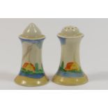 Pair of Clarice Cliff condiments, decorated with fir trees on a hill in colours against a honey