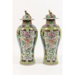 Pair of Chinese 'clobbered' export vases, early 19th Century with later decoration, each with a