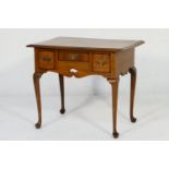 Walnut lowboy, fitted with three small drawers over a shaped apron, swan neck legs with pad feet,