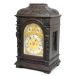 Victorian carved oak bracket clock, late 19th Century, carved caddy style top over a carved lion's