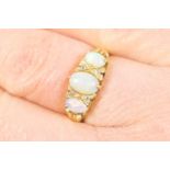 Opal and diamond cluster ring, the central cabochon opal approx. 6mm x 4mm bordered with tiny