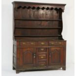 Late George II oak dresser and rack, North Wales, circa 1750, having a moulded cornice over a pot