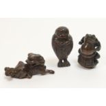 Three Japanese carved wooden netsukes, depicting mythical creatures, the tallest 5cm