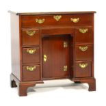 Mahogany kneehole dressing table, in the Georgian style, having a top with moulded edge over a