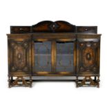 George V oak display sideboard, in Jacobean Revival style, having a back panel over two central