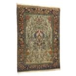 Kashan Tree of Life woollen rug, the fawn field displaying birds amidst tree branches, within a dark