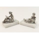 Pair of modern silver figural paperweights, third quarter 20th Century, each mounted on composite