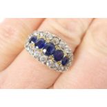 Sapphire and diamond cluster ring, centred with five oval cut sapphires totalling approx. 1ct, and