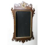 Walnut and parcel gilt fretwork wall mirror, late 19th Century, surmounted with a traditional ho-