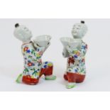 Pair of Chinese porcelain incense burners, 19th Century, modelled as boys kneeling and supporting