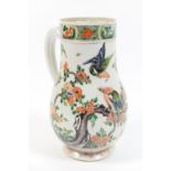 Chinese famille verte jug, Kangxi (1662-1722), baluster form decorated with birds amidst prunus