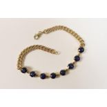 10ct gold and synthetic sapphire bracelet, curb links centred with eight round cut stones in claw