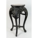 Chinese carved hardwood jardiniere stand, late 19th Century, with a marble inset top over a frieze