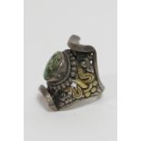 Tibetan or Nepalese silver gilt finger ring, having a turquoise stone mounted in the centre of the