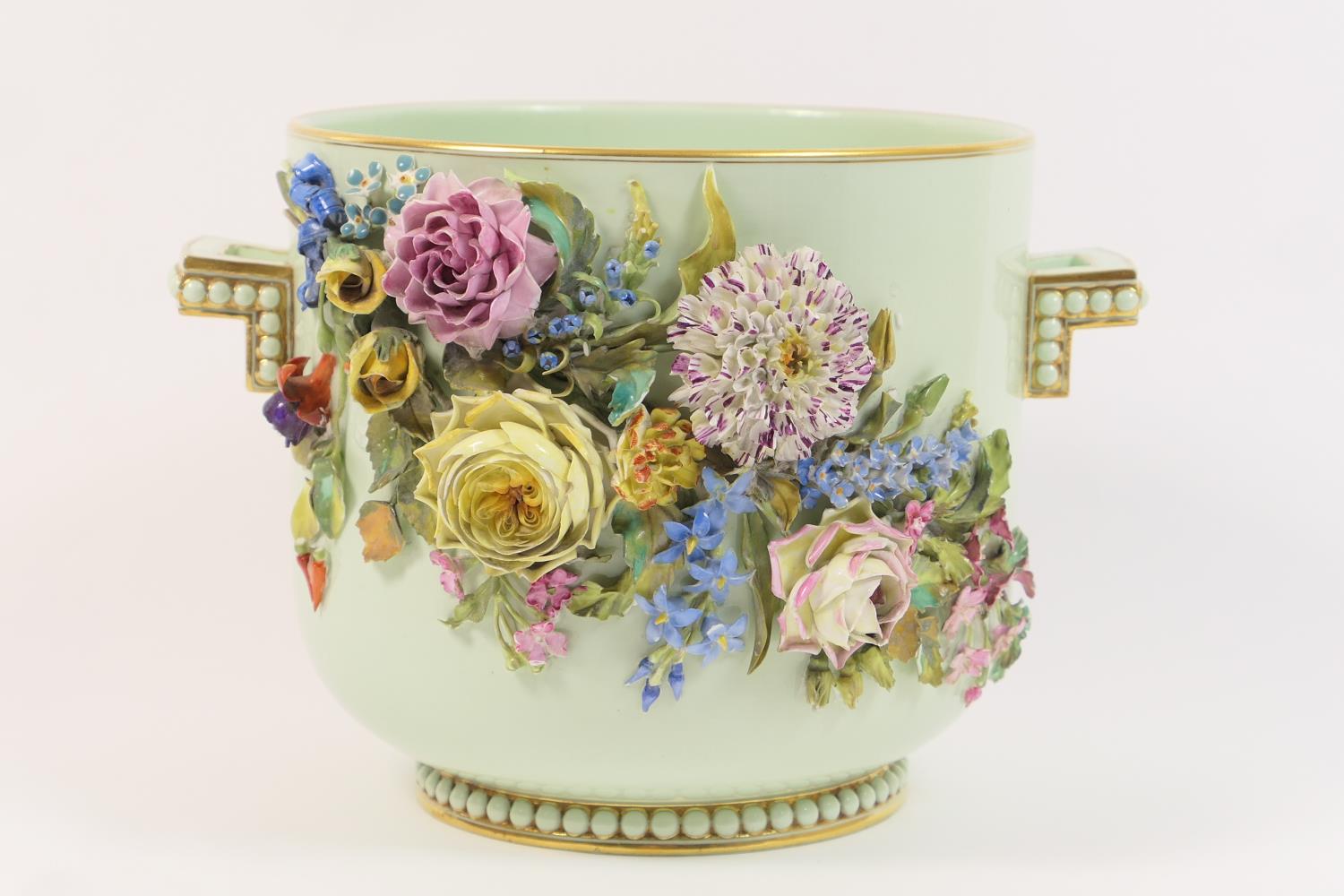 French porcelain floral encrusted jardiniere, pale celadon ground decorated with an abundance of