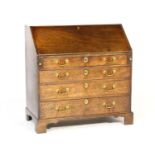 George III mahogany bureau, circa 1770, having a simple interior with pigeonholes, four long