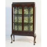 Late Victorian mahogany display cabinet, circa 1900, having a caddy style top over two glazed doors,