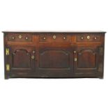 George II oak enclosed dresser, North Wales, circa 1740-60, having a two plank top over three