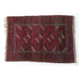 Turkman red ground woollen rug, the field with hooked botehs within a boteh border, size approx.