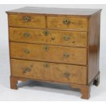 Walnut chest of drawers, 18th Century and later, the crossbanded top over two short and three long