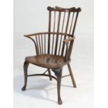 Yewood comb back Windsor chair, early 19th Century, with a shaped top rail, shaped elm seat raised