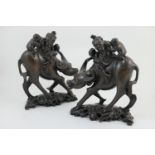 Pair of Chinese carved wooden water buffalo, circa 1900, ridden along by an elderly traveller with