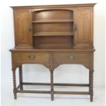 Arts and Crafts inspired oak and inlaid dresser, circa 1900-1910, the back fitted with two