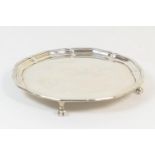 George VI silver card tray, London 1938, plain circular form with raised edge, on four claw and ball